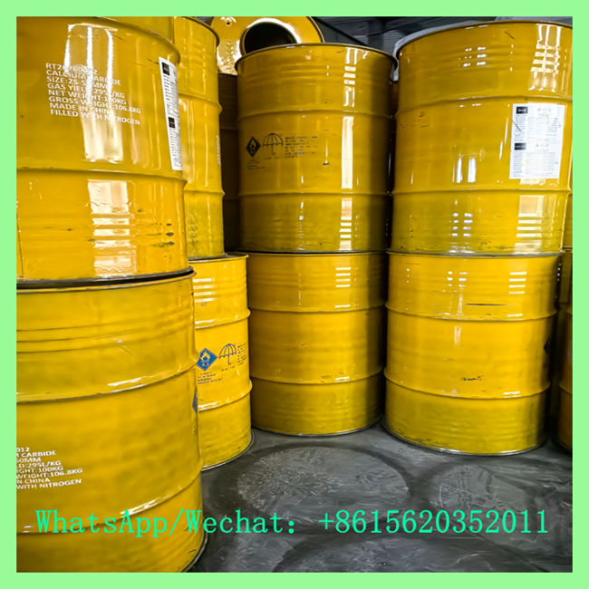 UN approved yellow steel drums of calcium carbide for sale in chemical storage warehouse