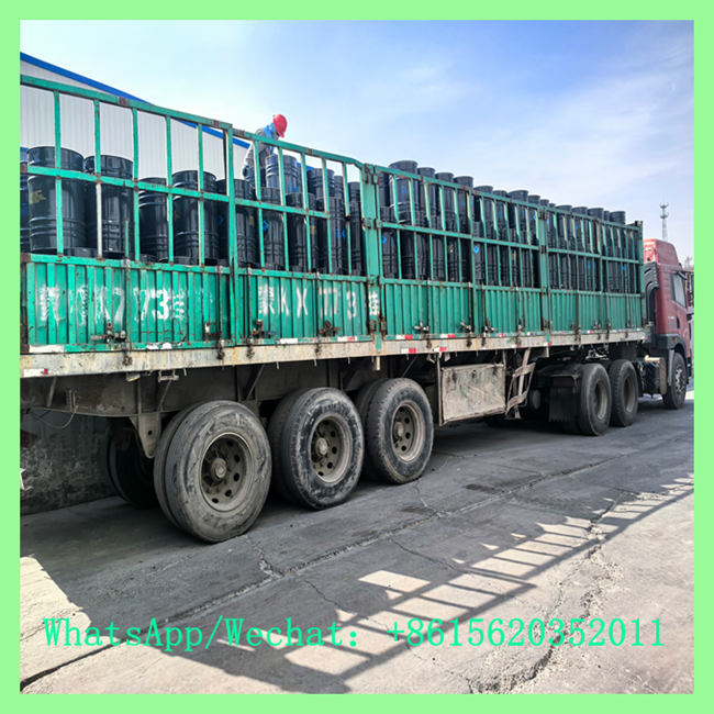Flatbed truck loaded with black calcium carbide 50kg drum units for logistics transport