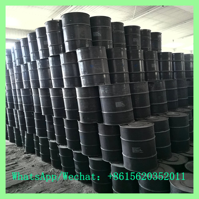 Multiple tiers of black industrial steel drums for Calcium Carbide storage stacked high in a warehouse. WhatsApp/Wechat: +8615620352011 for quotes.