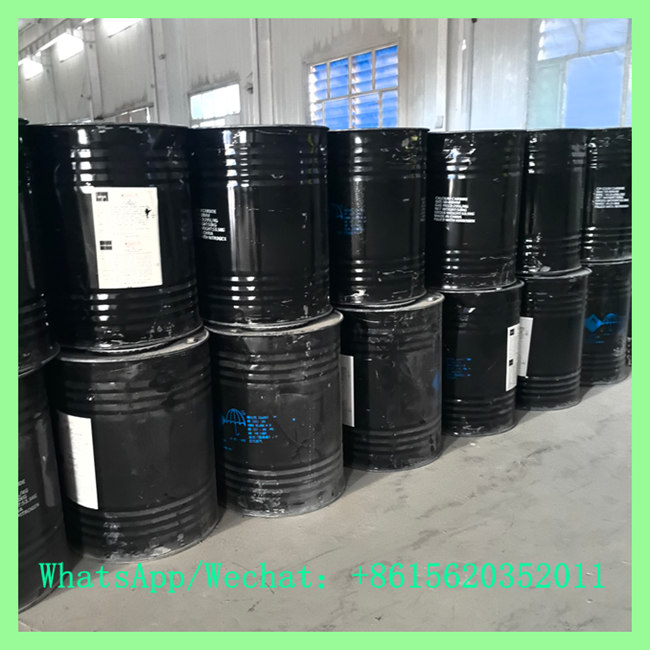 Sealed black steel drums filled with 2-7mm calcium carbide fine granules stacked inside a chemical warehouse. WhatsApp/Wechat: +8615620352011