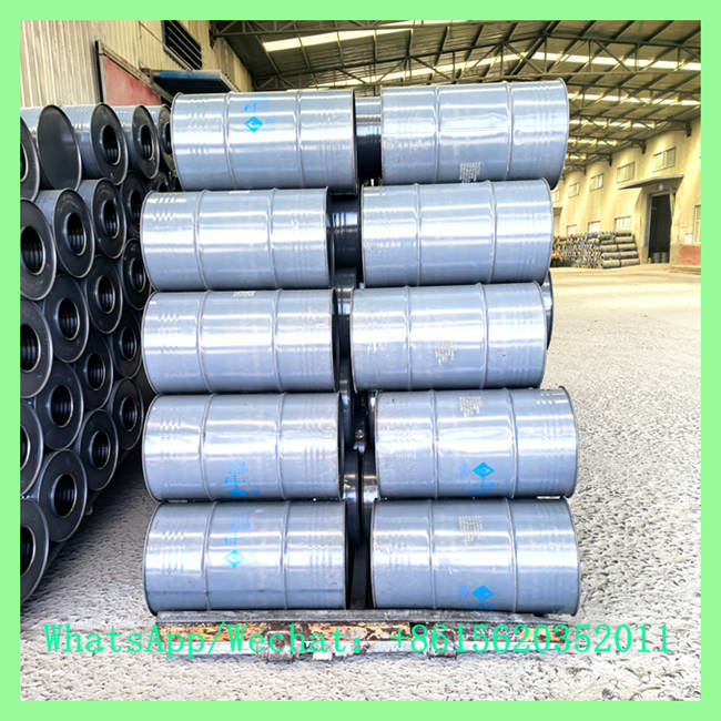 A neat stack of grey chemical steel drums containing calcium carbide 7-15mm secured on wooden pallets. WhatsApp/Wechat: +8615620352011