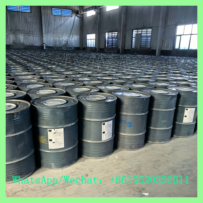 Massive warehouse storage with neat rows of grey UN steel drums packed with 7-15mm calcium carbide granules. Contact WhatsApp/Wechat: +8615620352011