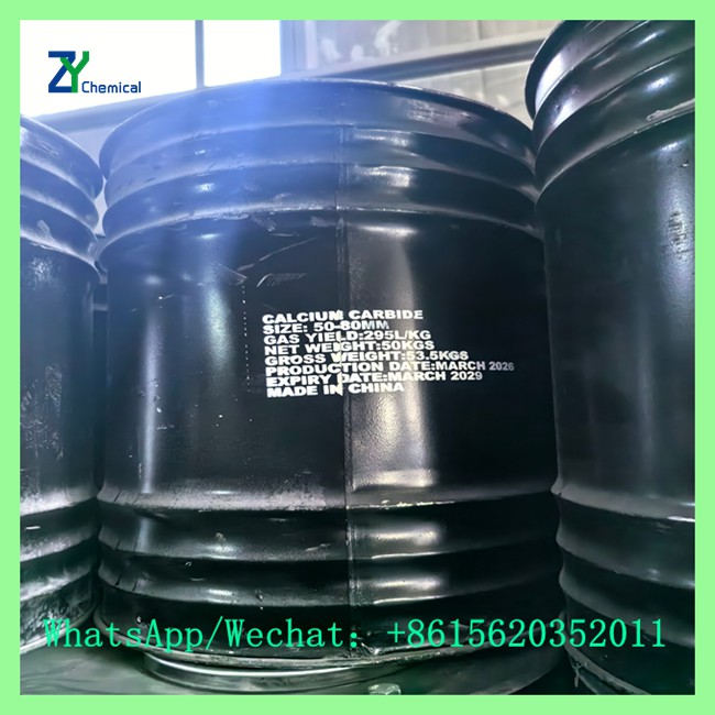 Close-up of a black metal industrial drum labeled with calcium carbide specifications, including 50-80mm size and 295L/KG gas yield.
