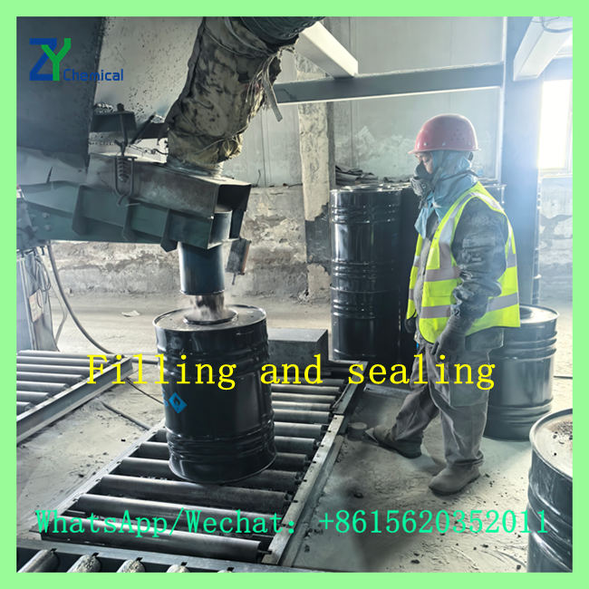 Worker operating automated filling line for packaging calcium carbide stone at factory direct price