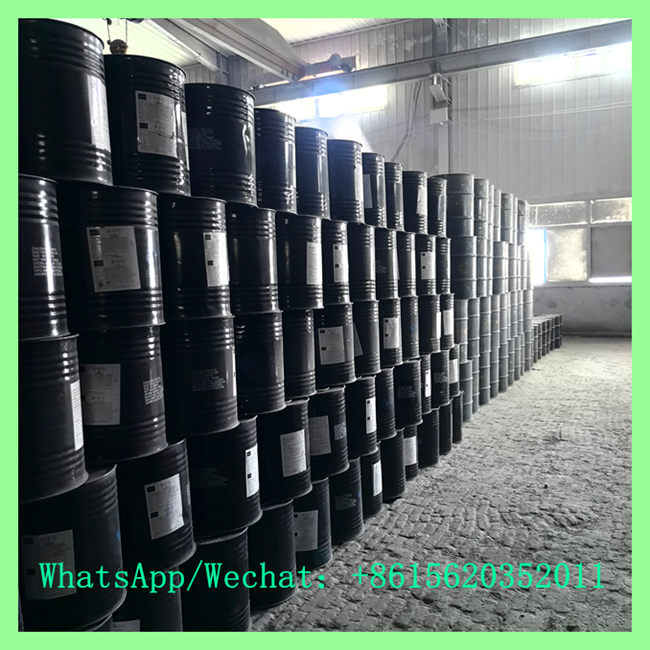 Industrial Calcium Carbide Manufacturer Warehouse with Stacked Black Iron Drums