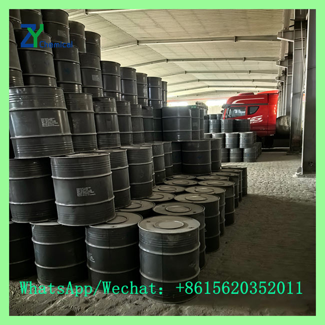 Stacked steel drums of calcium carbide for sale near me stored in factory warehouse near delivery truck
