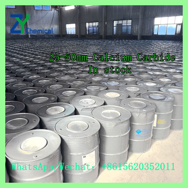 In-stock steel drums filled with 25-50mm calcium carbide lumps lined up in warehouse