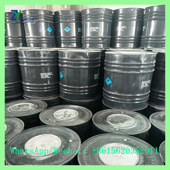 Close-up of stacked black UN iron drums storing industrial calcium carbide lumps 25-50mm