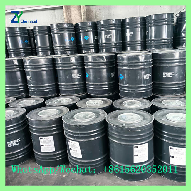 Sealed black iron drums containing China calcium carbide 50-80mm stacked in factory warehouse
