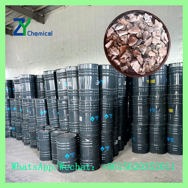 Calcium carbide steel making lump sample shown above warehouse stacked chemical drums