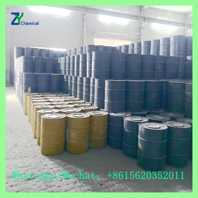 Customized yellow and black steel drums containing acetylene calcium carbide raw material in factory warehouse