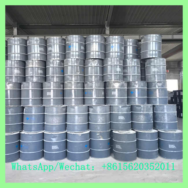 Industrial grade CaC2 acetylene calcium carbide packed in sealed grey steel drums stacked in factory warehouse for bulk export supply