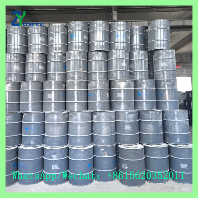 High stack of sealed gray steel drums filled with cac2 calcium carbide in chemical factory warehouse
