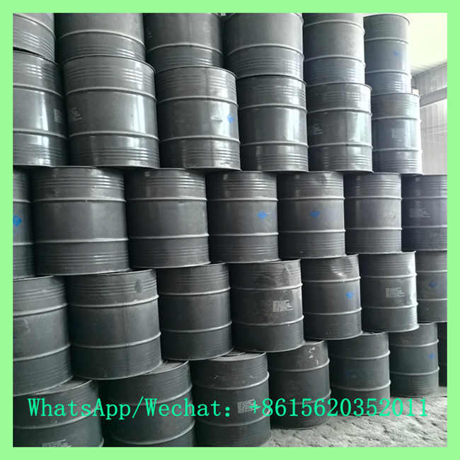 Industrial grade calcium carbide CaC2 packed in sealed metal drums stacked in chemical factory warehouse
